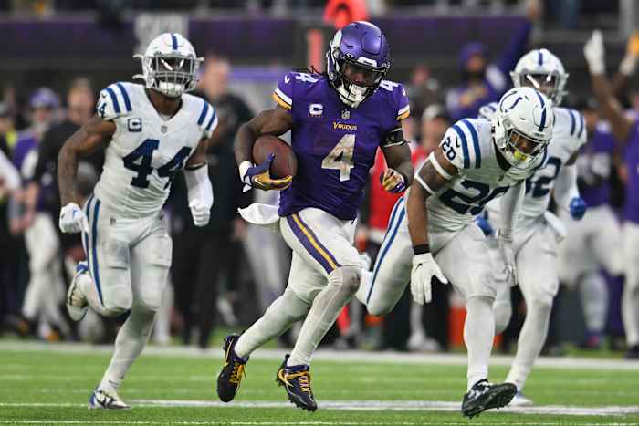 Dec 17, 2022; Minneapolis, Minnesota, USA; Minnesota Vikings running back Dalvin Cook (4) scores on a touchdown reception as Indianapolis Colts linebacker Zaire Franklin (44) and safety Rodney McLeod (26) pursue late during the fourth quarter at U.S. Bank Stadium.
